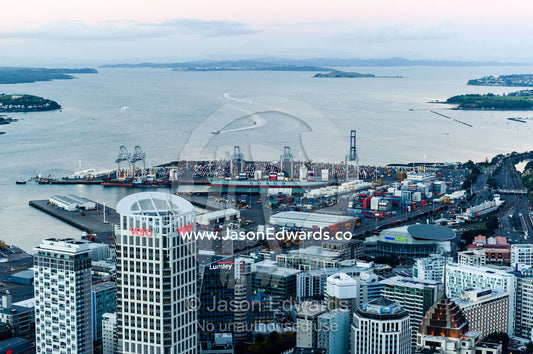 Looking over a city skyline and industrial shipping port to the sea. Half Moon Bay, Waitemata Harbour, Auckland City, Aukland, New Zealand.