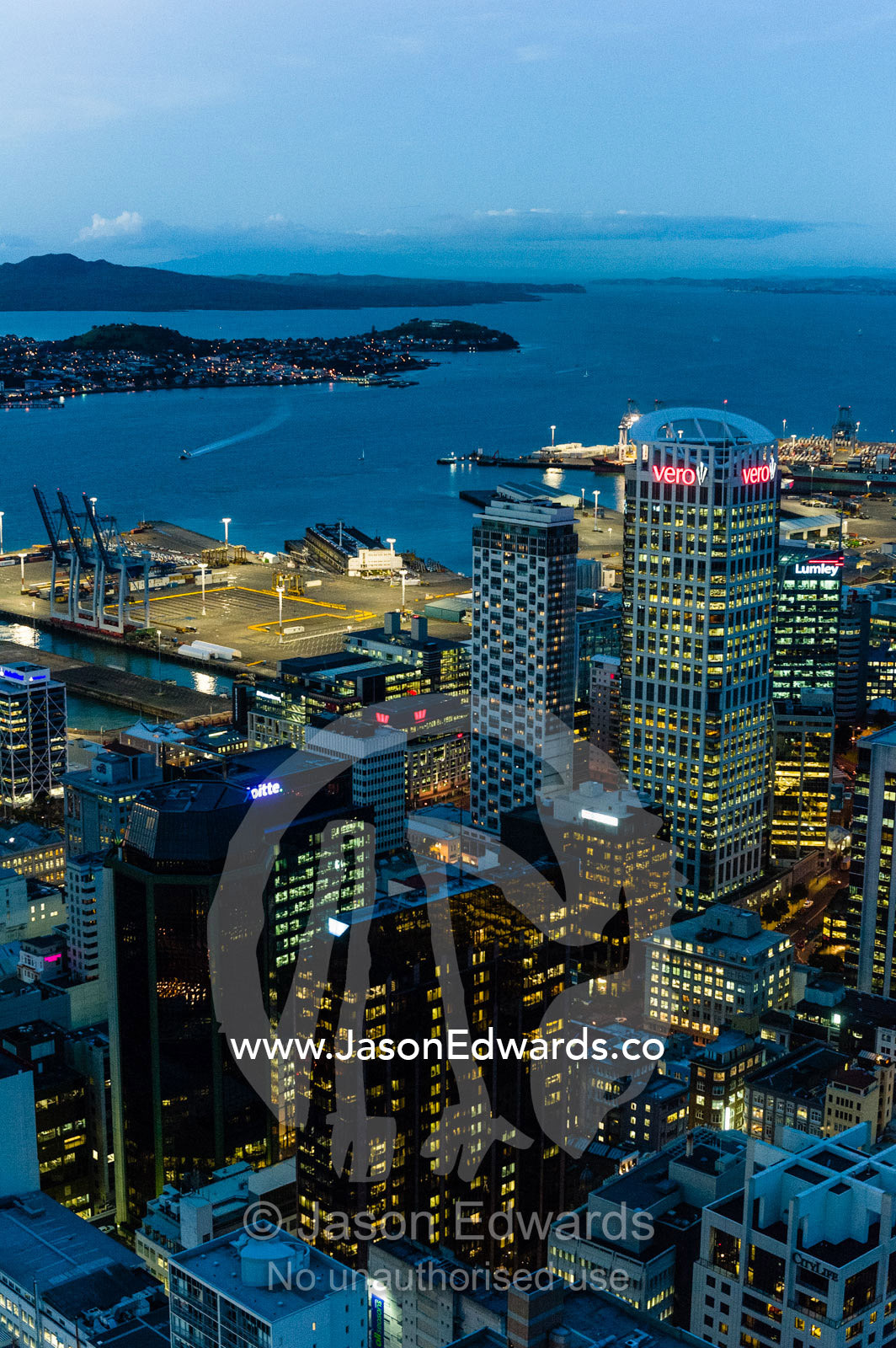 The neon lights of the Auckland city skyline overing Half Moon Bay. Half Moon Bay, Waitemata Harbour, Auckland City, Aukland, New Zealand.