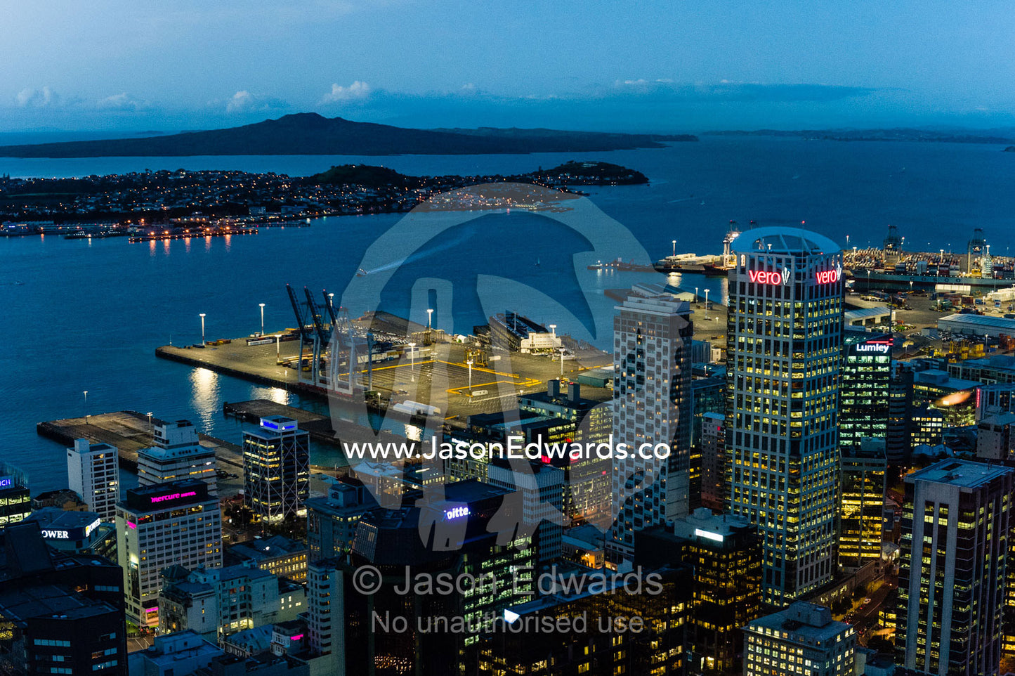 The neon lights of the Auckland city skyline overing Half Moon Bay. Half Moon Bay, Waitemata Harbour, Auckland City, Aukland, New Zealand.