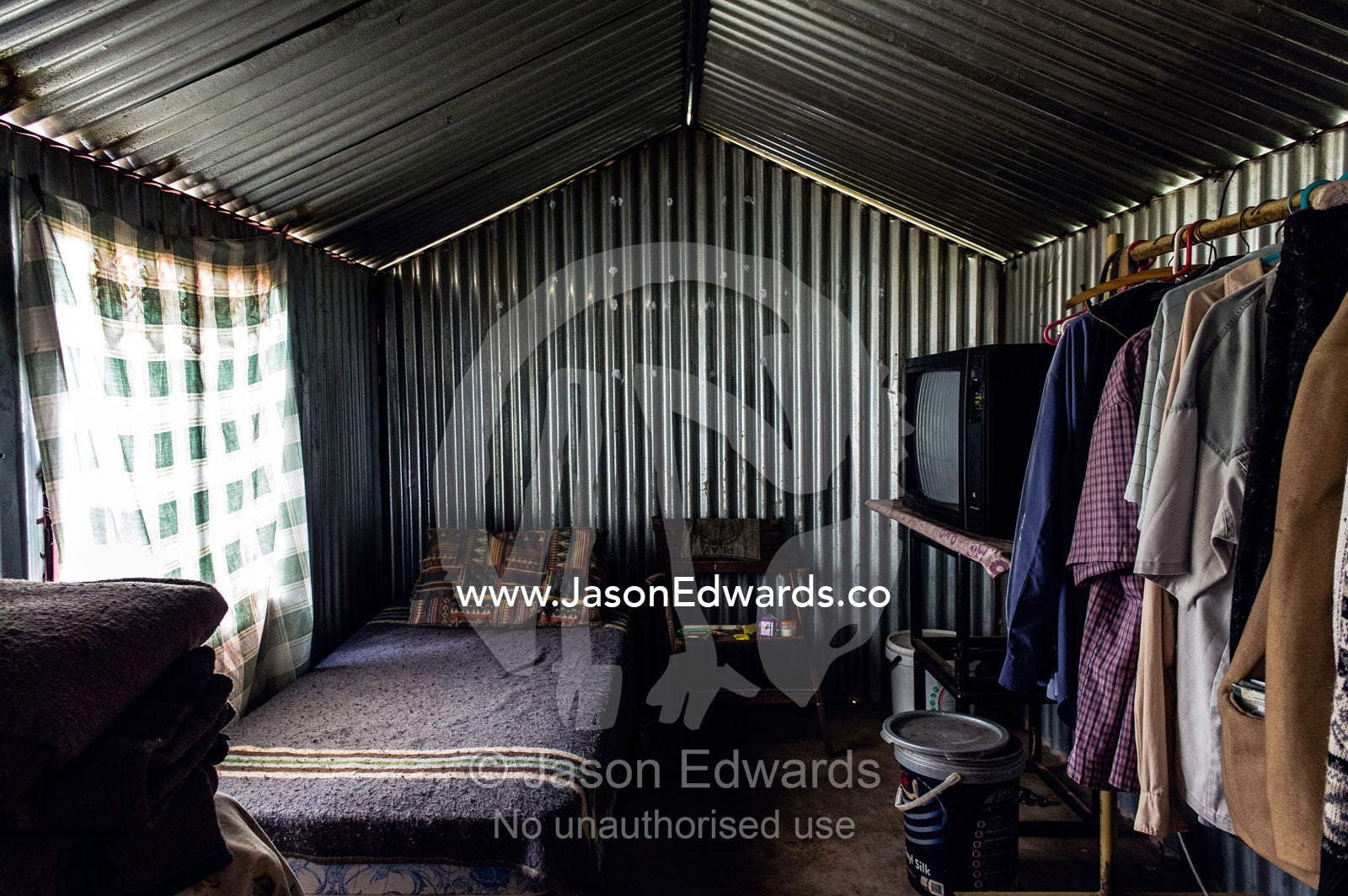 A corrugated tin garden shed becomes a home in a displaced community. Bon Accord Dam, Gauteng Province, South Africa.