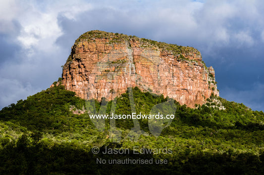 A rugged escarpment cliff face surrounded by a dense forest canopy. Entabeni Mountain, Waterberg Mountains, Entabeni Game Reserve, Limpopo Province, South Africa.