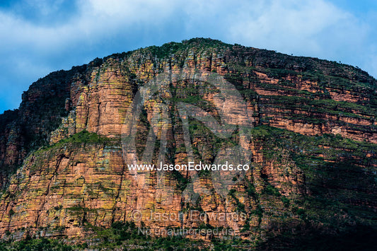 The weathered and cracked cliff face of a table-top mountain. Waterberg Mountains, Entabeni Game Reserve, Limpopo Province, South Africa.