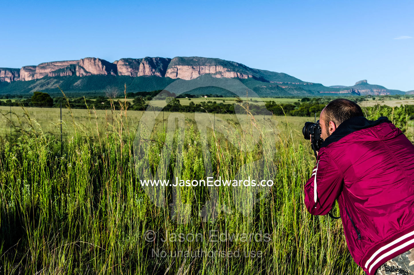 A photographer captures a mountain range on a sunny morning. Waterberg Mountains, Entabeni Game Reserve, Limpopo Province, South Africa.