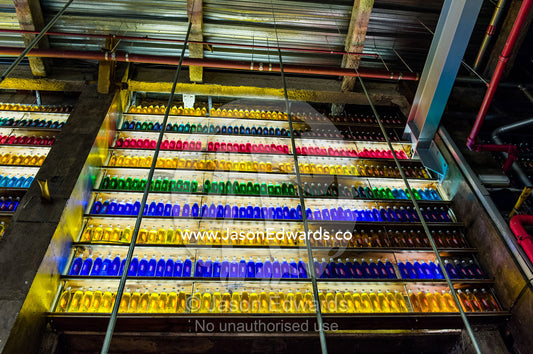 Backlit colorful bottles decorate a wall in a bar in a shopping mall. Menlyn Park, Pretoria, Menlyn Mall, Pretoria, Gauteng Province, South Africa.