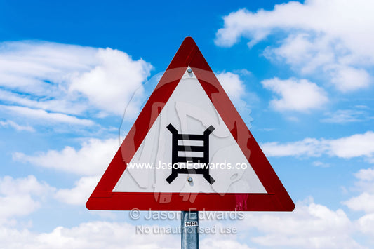 A sign warning of the danger of an upcoming railway crossing. Waterkloof 101, Pretoria, Gauteng Province, South Africa.