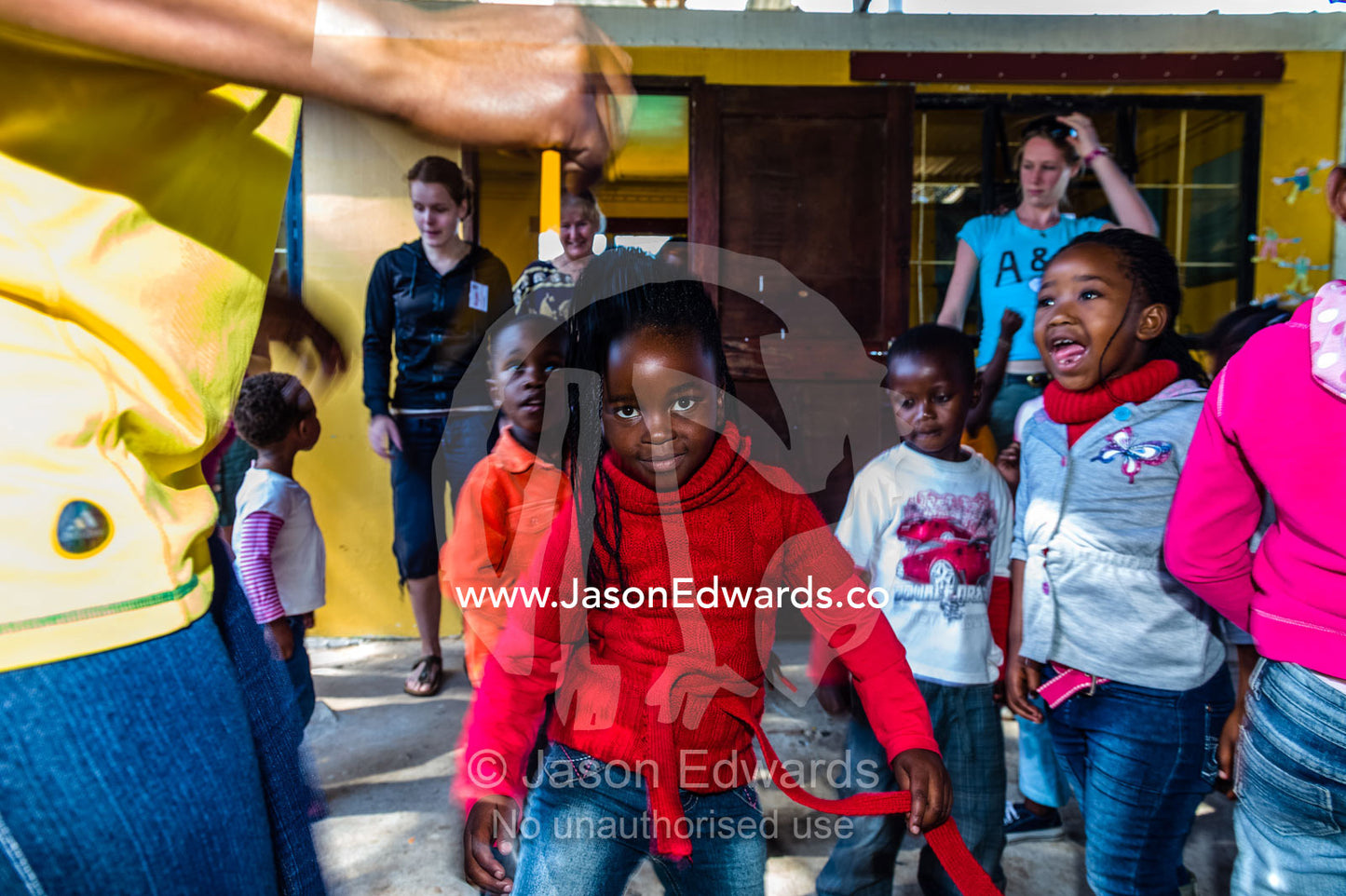 Girls dance to African music during a break from classes at school. Red Hill Township and Pre-School, Cape Town, Western Cape, South Africa.