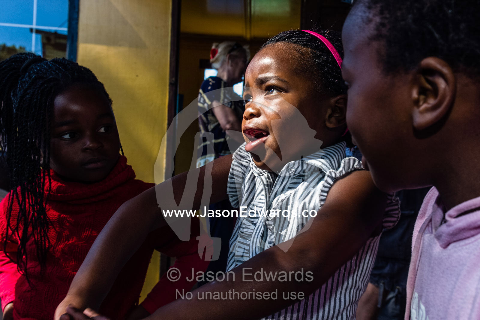 Girls dance to African music during a break from classes at school. Red Hill Township and Pre-School, Cape Town, Western Cape, South Africa.