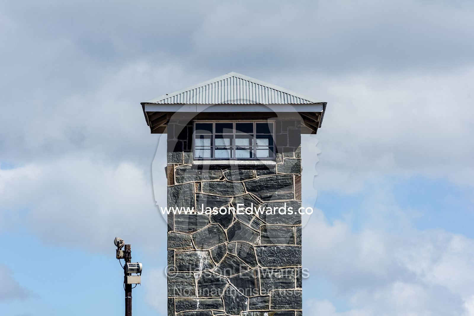 Windows of a guard post look out from a stone prison watch tower. Robben Island, Cape Town, Bloubergstrand, Table Bay, Western Cape, South Africa.