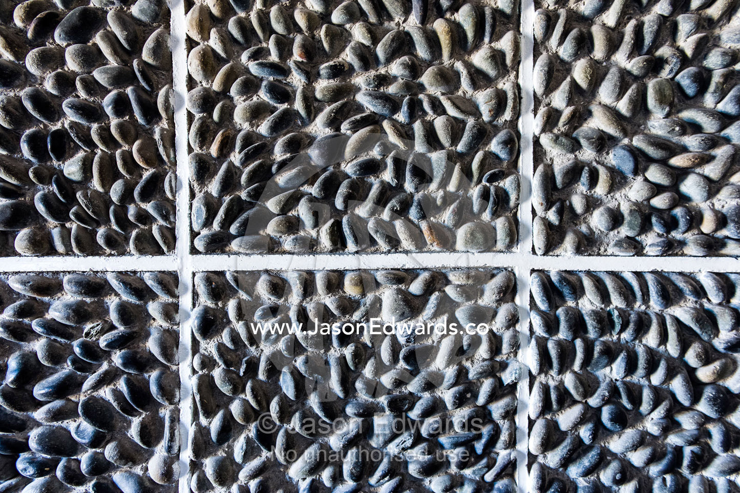 A textured prison wall imbedded with stones and pebbles. Robben Island, Cape Town, Bloubergstrand, Table Bay, Western Cape, South Africa.