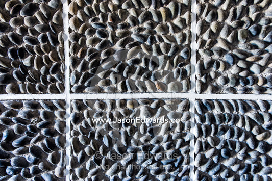 A textured prison wall imbedded with stones and pebbles. Robben Island, Cape Town, Bloubergstrand, Table Bay, Western Cape, South Africa.