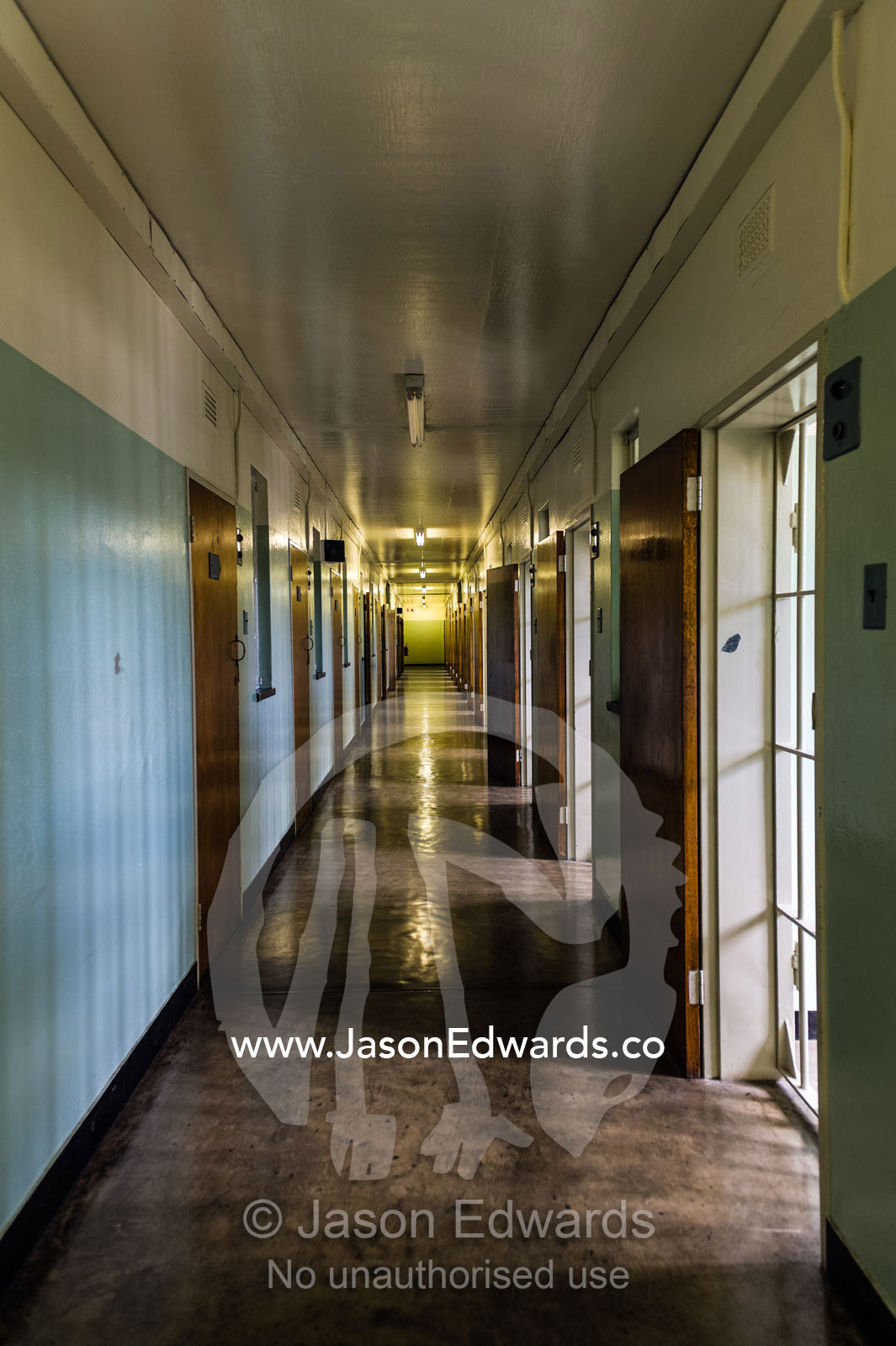 A corridor leads past Nelson Mandela's prison cell on Robben Island. Robben Island, Cape Town, Bloubergstrand, Table Bay, Western Cape, South Africa.