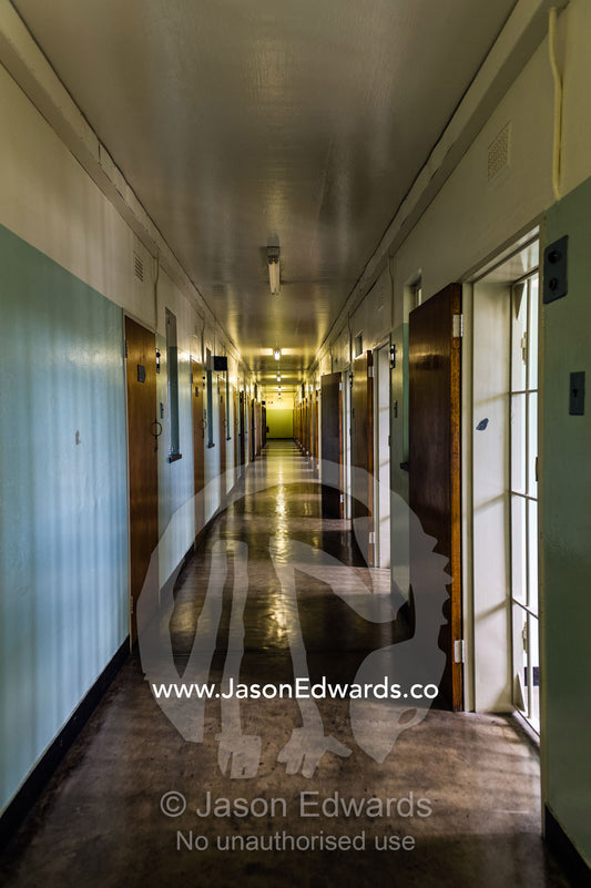 A corridor leads past Nelson Mandela's prison cell on Robben Island. Robben Island, Cape Town, Bloubergstrand, Table Bay, Western Cape, South Africa.