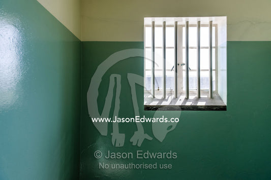 A lone window illuminates the prison cell inhabited by Nelson Mandela. Robben Island, Cape Town, Bloubergstrand, Table Bay, Western Cape, South Africa.
