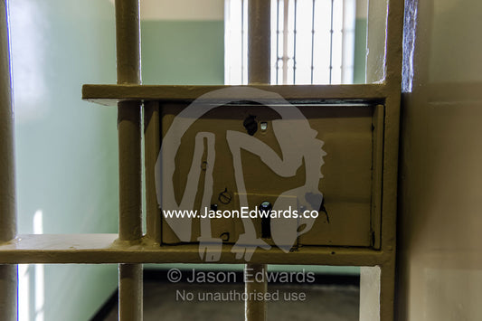 The steel bars and lock on the cell door that held Nelson Mandela. Robben Island, Cape Town, Bloubergstrand, Table Bay, Western Cape, South Africa.