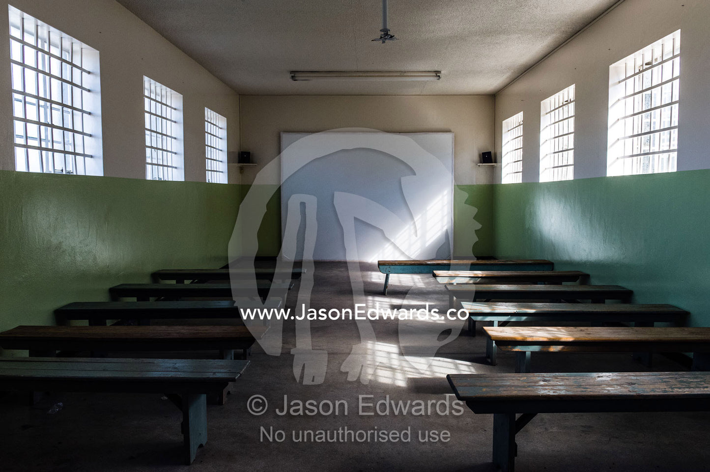 Student benches in a classroom where prisoners were taught lessons. Robben Island, Cape Town, Bloubergstrand, Table Bay, Western Cape, South Africa.
