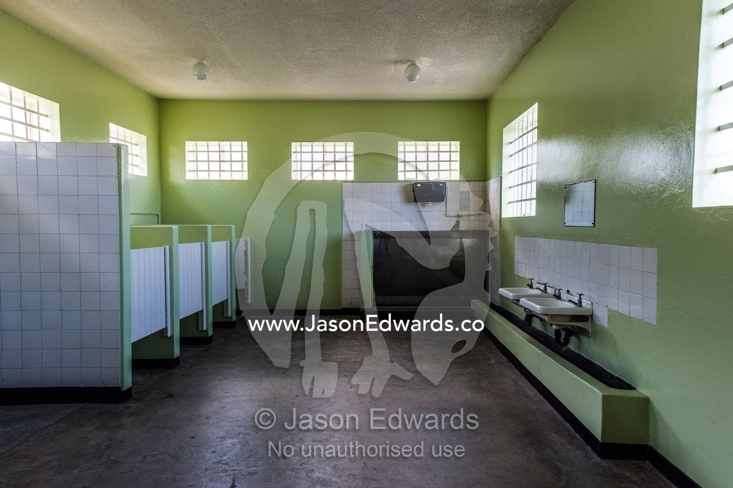 Male toilets, urinal and washbasins in a prison bathroom. Robben Island, Cape Town, Bloubergstrand, Table Bay, Western Cape, South Africa.