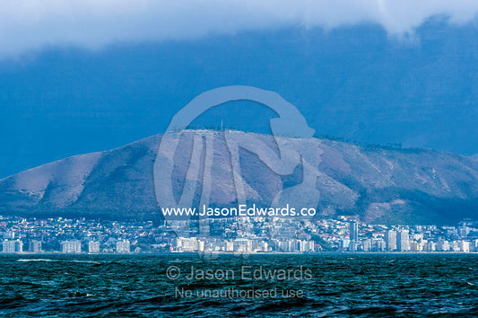 The city and suburbs of Cape Town across the Table Bay sea channel. Robben Island, Cape Town, Bloubergstrand, Table Bay, Western Cape, South Africa.