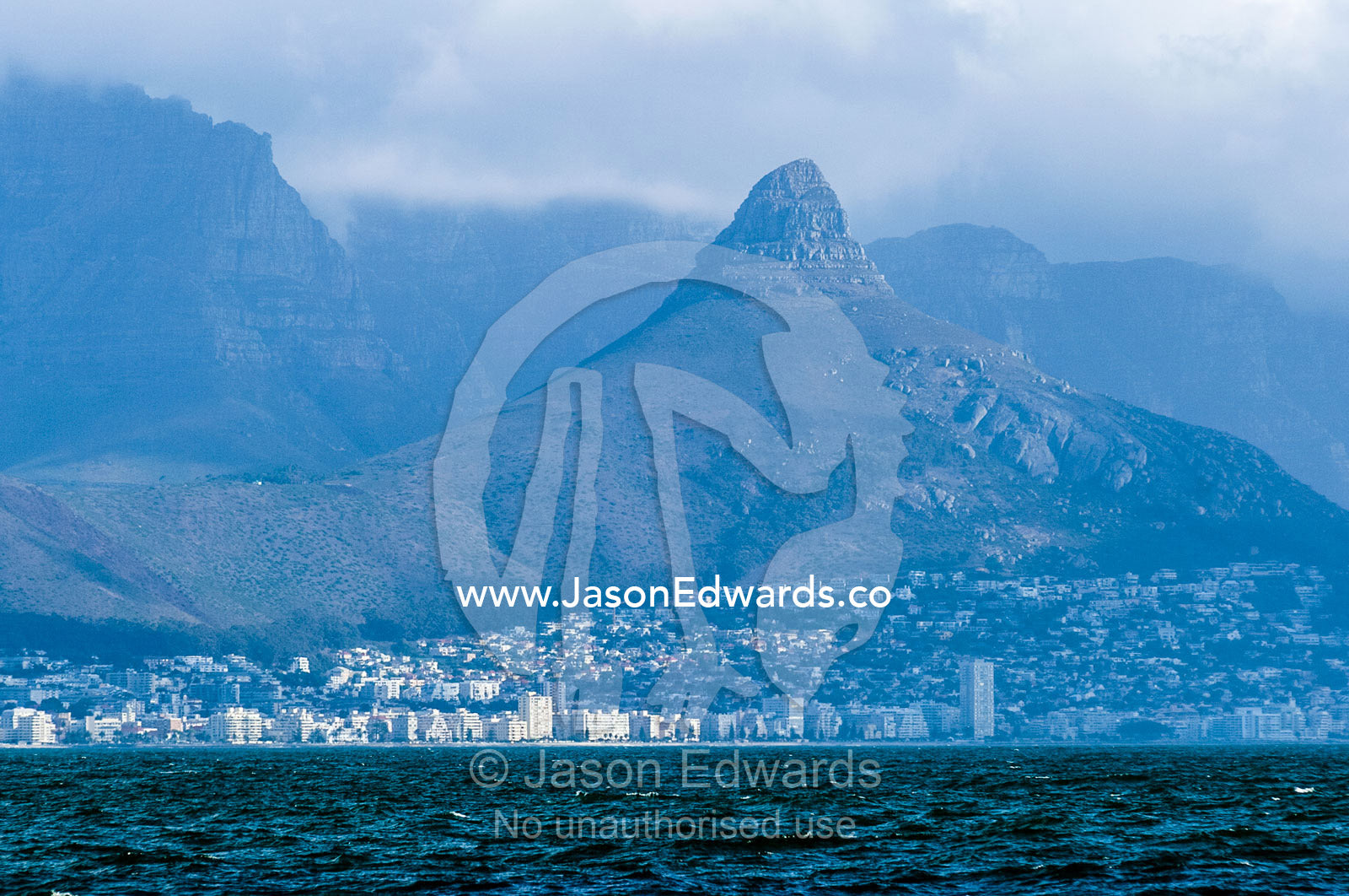 The city and suburbs of Cape Town across the Table Bay sea channel. Robben Island, Cape Town, Bloubergstrand, Table Bay, Western Cape, South Africa.