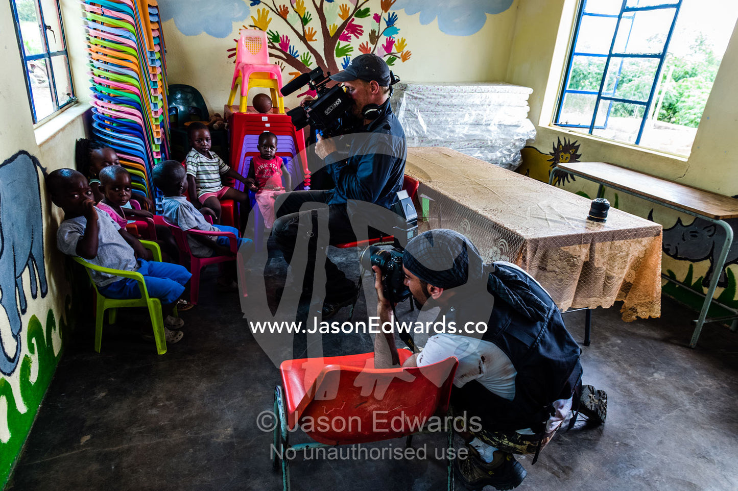 A film crew photographs children in a small African Primary school. Kruger National Park, Manyeleti, Shalati Village, Mnisi Community, Limpopo, South Africa.