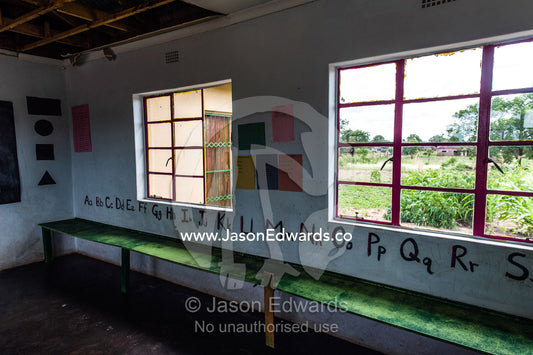 The alphabet runs along a classroom wall in a small African school. Kruger National Park, Manyeleti, Shalati Village, Mnisi Community, Limpopo, South Africa.