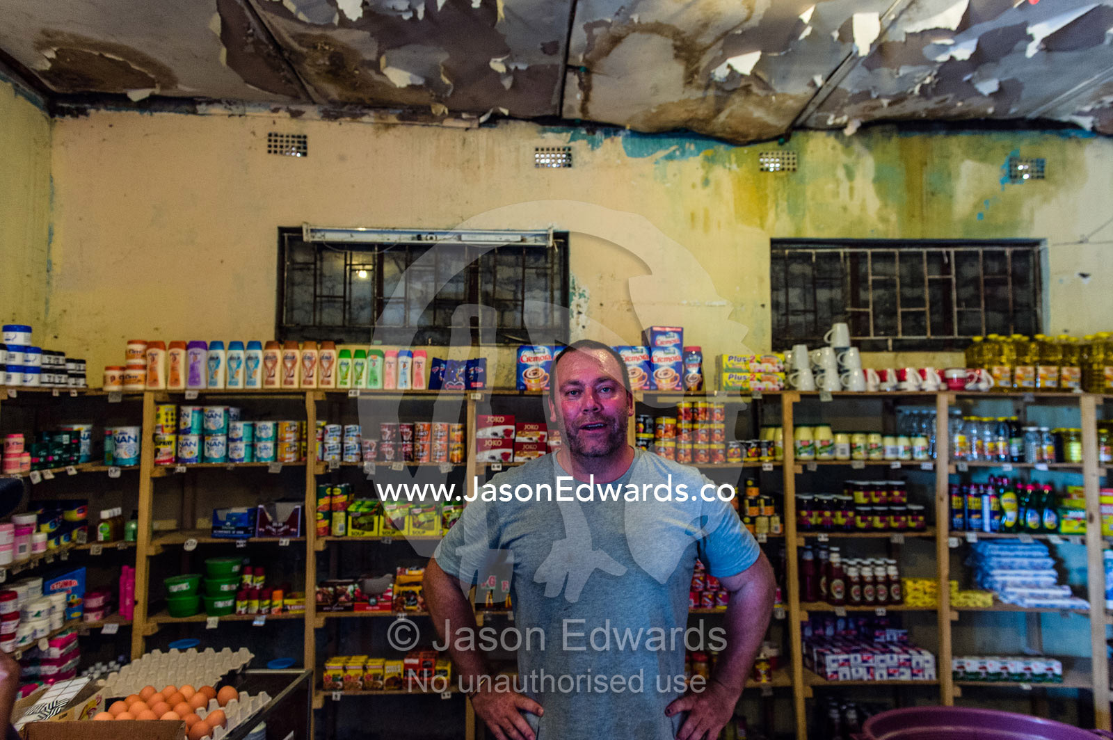 A man shopping in a small African general store. Kruger National Park, Manyeleti, Shalati Village, Mnisi Community, Limpopo, South Africa.
