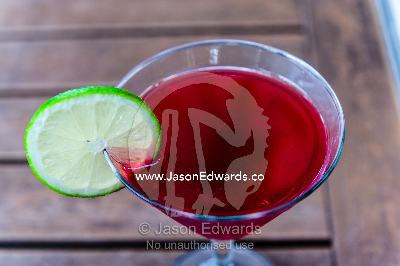 A raspberry cocktail with a slice of lime on the rim of the glass. Kuka Bar, Hazyview, Mpumalanga, South Africa.
