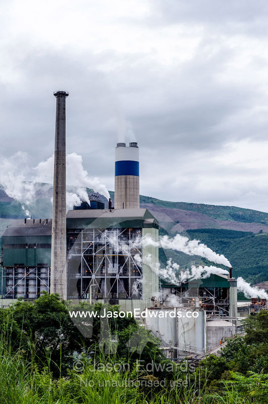 Smoke and steam pollution belch from chimneys in a paper mill. Sappi's Ngodwana Mill, Nelspruit, Mpumalanga Province, South Africa.