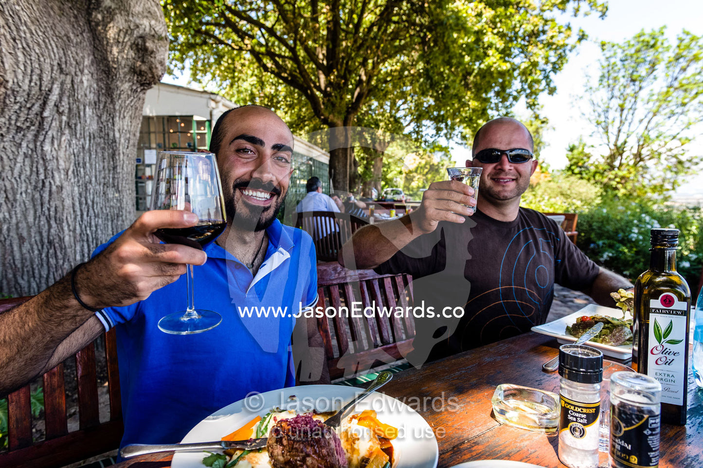 Tourists enjoy gourmet food and superb wine at a vineyard restaurant. Spice Route Winery, Stellenbosch, Western Cape, South Africa.