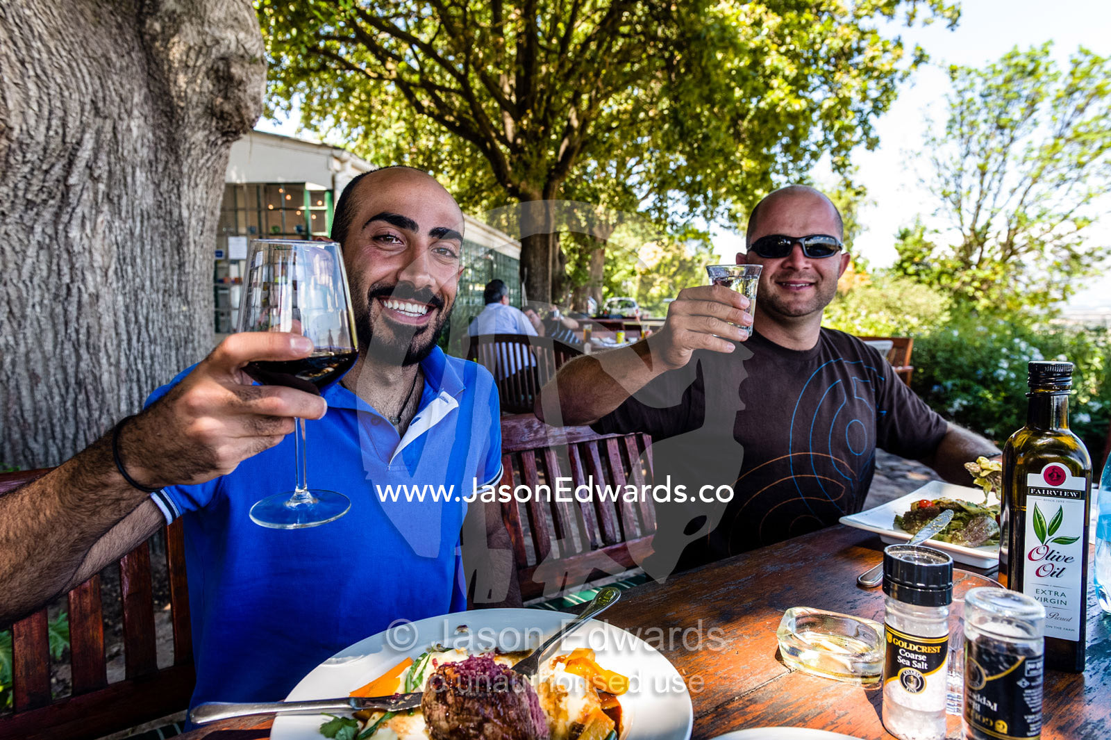 Tourists enjoy gourmet food and superb wine at a vineyard restaurant. Spice Route Winery, Stellenbosch, Western Cape, South Africa.