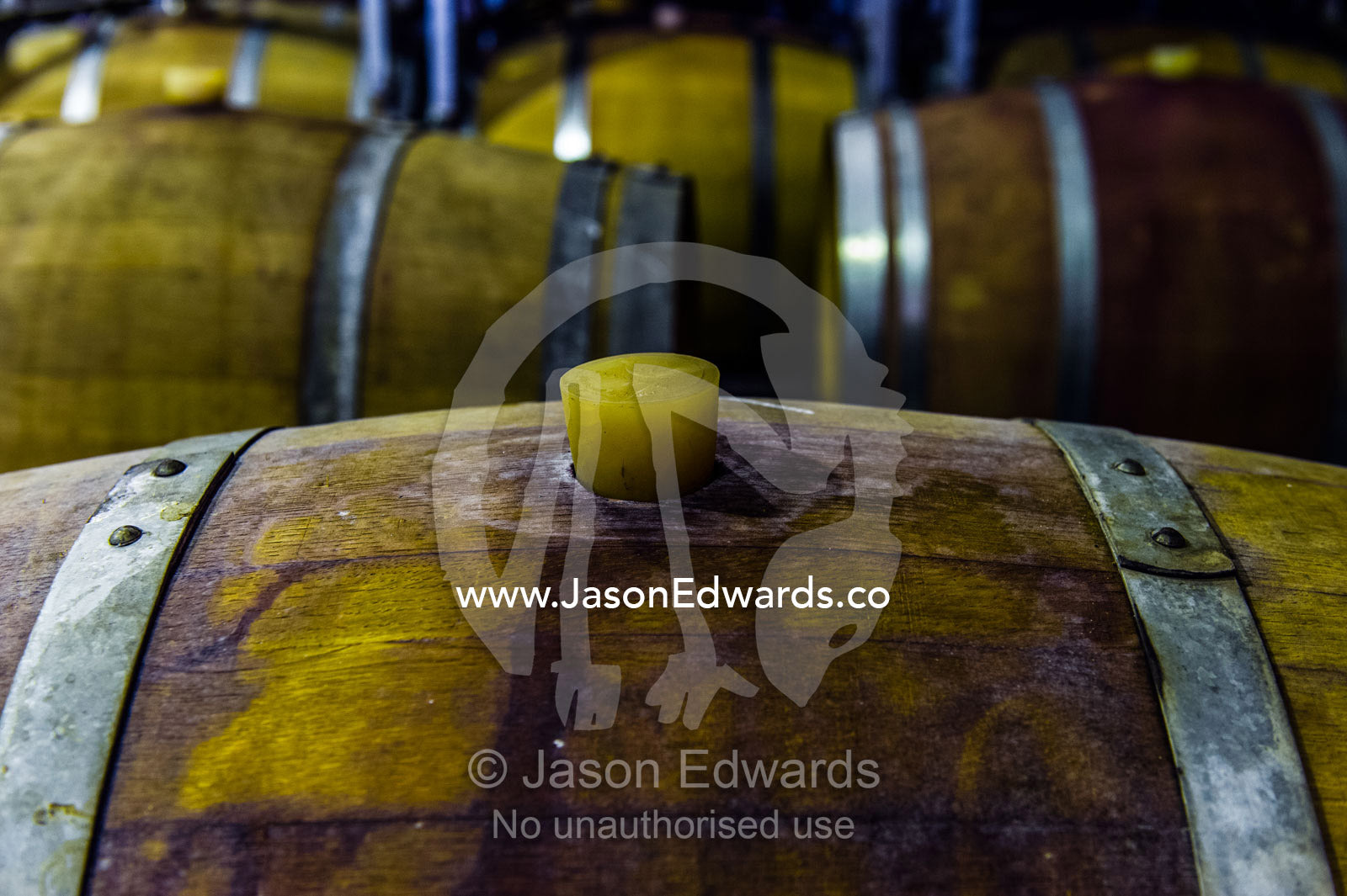 A rubber bung is used to seal a wine barrel at a vineyard. Fairview Wine Estate, Stellenbosch, Western Cape, South Africa.