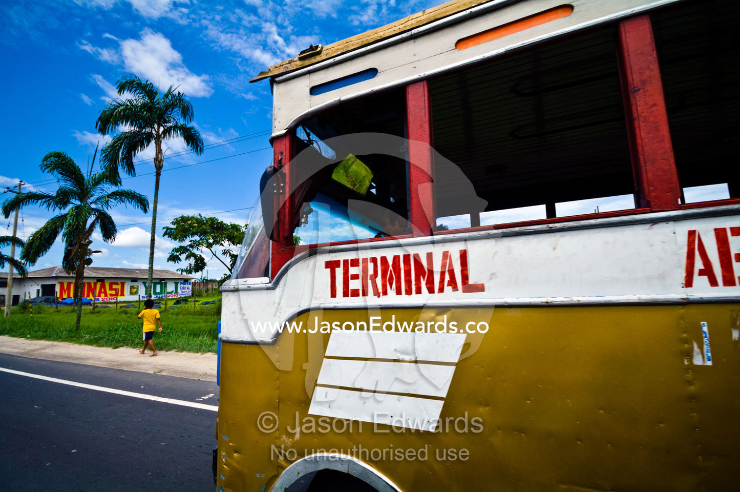 A windowless bus provides public transportation between communities in an Amazon river town. Iquitos, Amazon Basin, Loreto Region, Maynas Province, Peru.