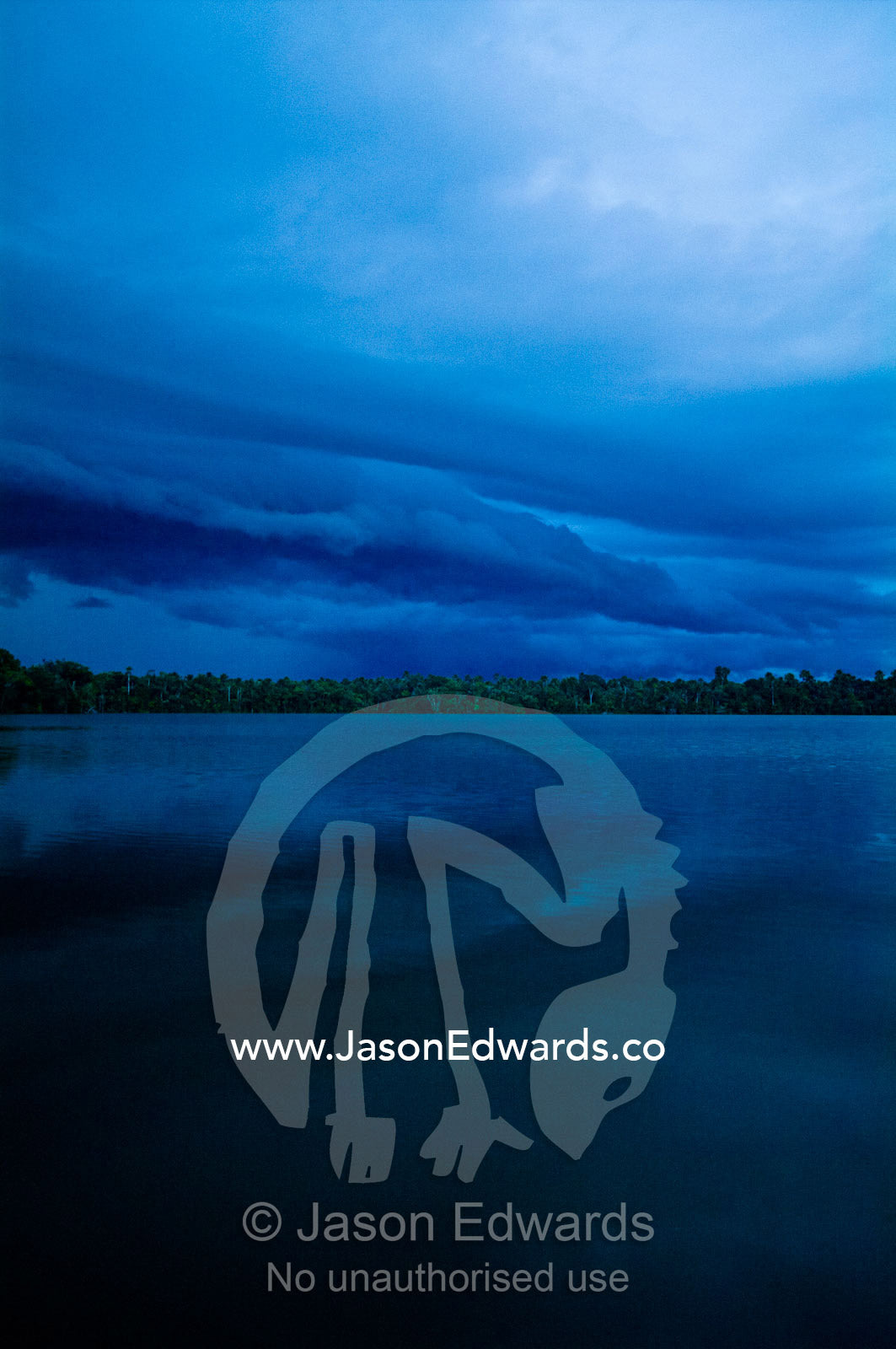 An ominous and brooding tropical storm rolls in over the Amazon rainforest along a lake. Quistococha Lake, Lago de Quistococha, Parque de Quistococha, Quistococha Zoo, Iquitos, Amazon Basin, Loreto Region, Maynas Province, Peru.
