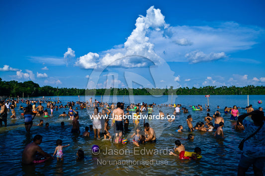 Families and children from a river town swimming in an Amazonian lake on a hot weekend afternoon. Quistococha Lake, Iquitos, Amazon Basin, Loreto Region, Maynas Province, Peru.
