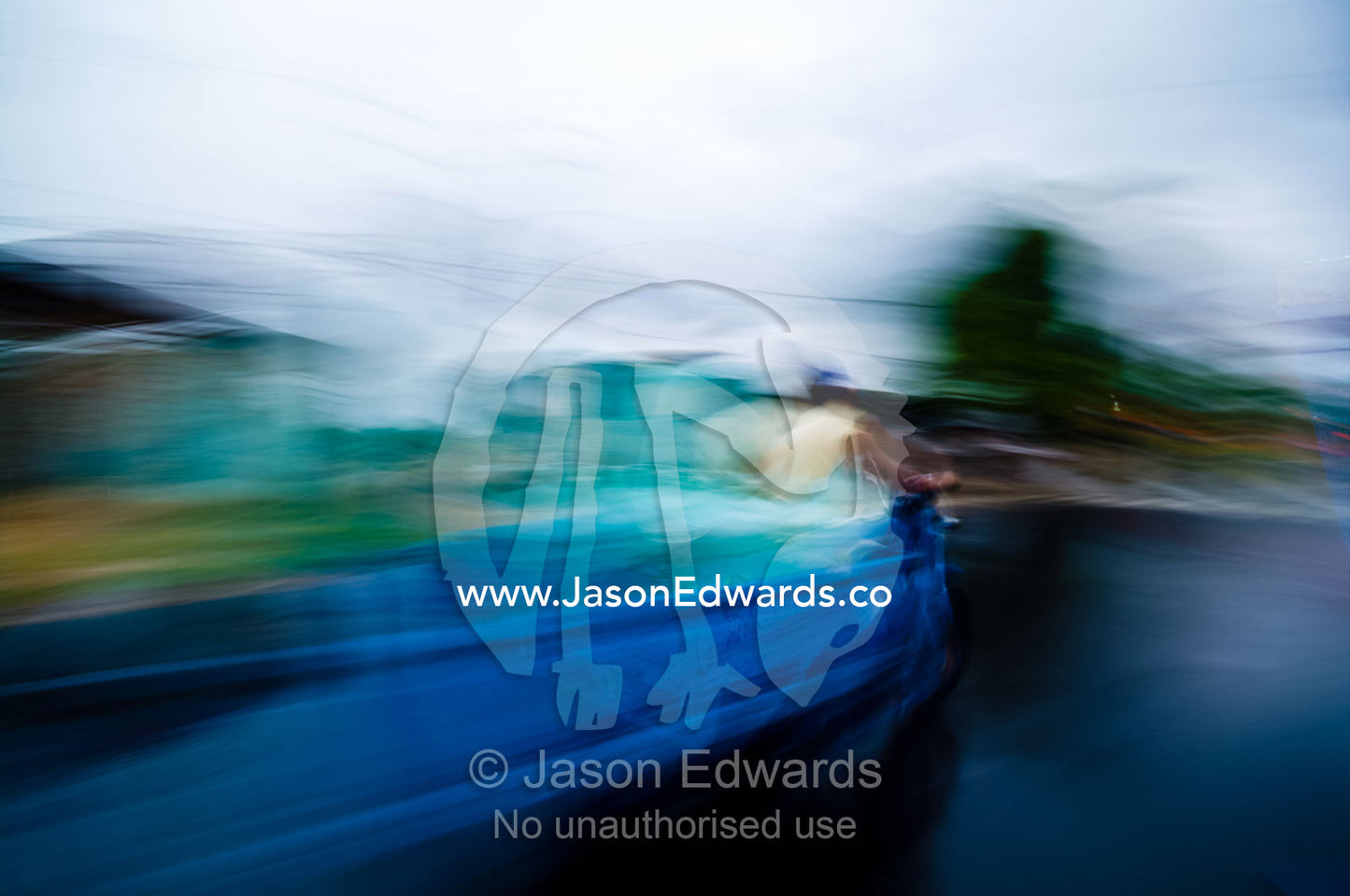 An auto rickshaw speeds along a wet road on a rainy night in an Amazon River town. Iquitos, Amazon Basin, Loreto Region, Maynas Province, Peru.