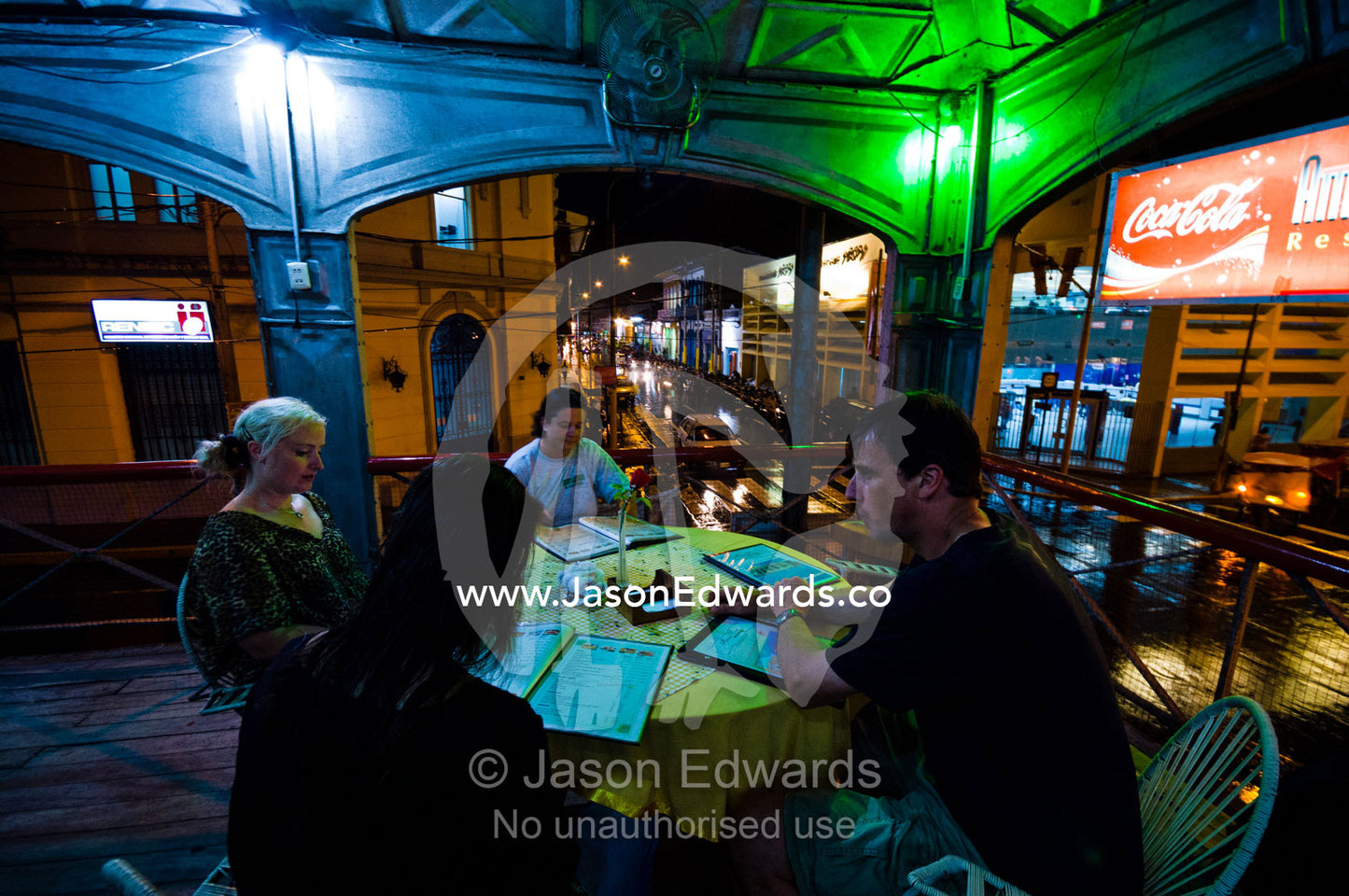 Tourists dine on the balcony of an antique steel restaurant in an Amazon river town. Iquitos, Amazon Basin, Loreto Region, Maynas Province, Peru.