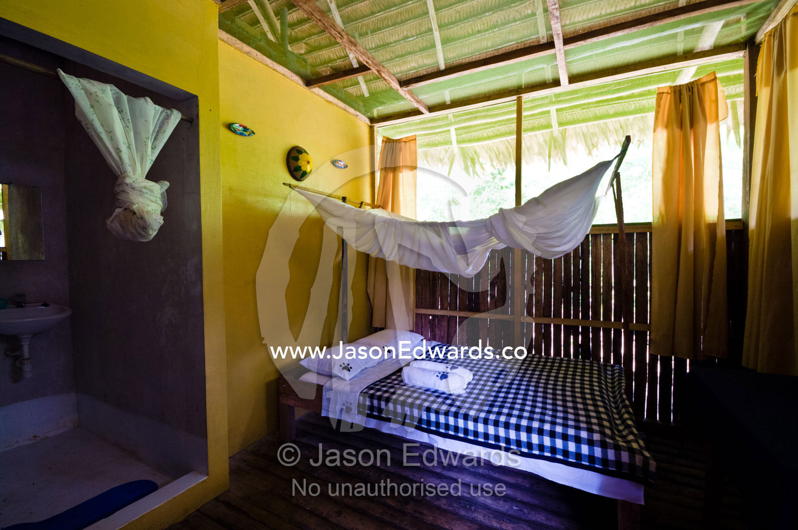 A bed and mosquito net for tourists in a lodge in the Amazon rainforest. Amazon River, Amazon Basin, Loreto Region, Maynas Province, Peru.