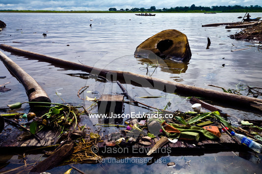 Pollution, logs and rubbish line the shore of the Amazon River near logging mills. Puerto Masusa, Iquitos, Amazon River, Rio Amazonas, Amazon Basin, Loreto Region, Maynas Province, Peru.