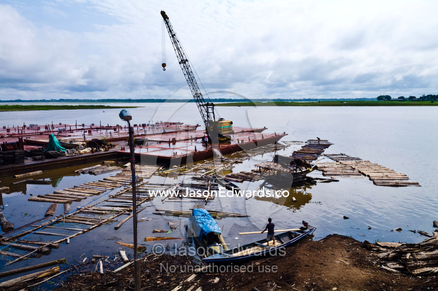 Empty logging mill barges moored on the shore of the Amazon river waiting to collect more trees. Puerto Masusa, Iquitos, Amazon River, Rio Amazonas, Amazon Basin, Loreto Region, Maynas Province, Peru.