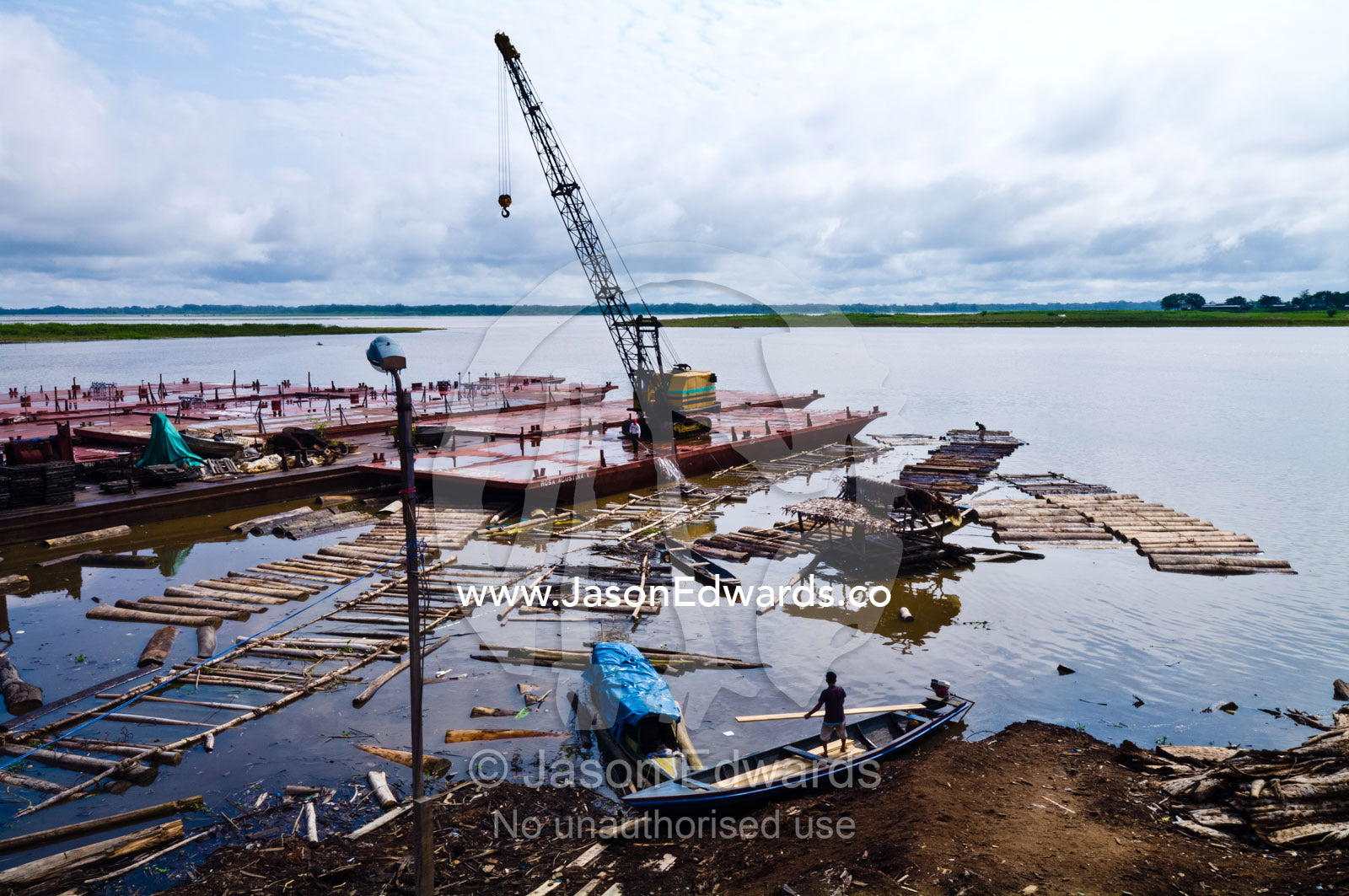 Empty logging mill barges moored on the shore of the Amazon river waiting to collect more trees. Puerto Masusa, Iquitos, Amazon River, Rio Amazonas, Amazon Basin, Loreto Region, Maynas Province, Peru.