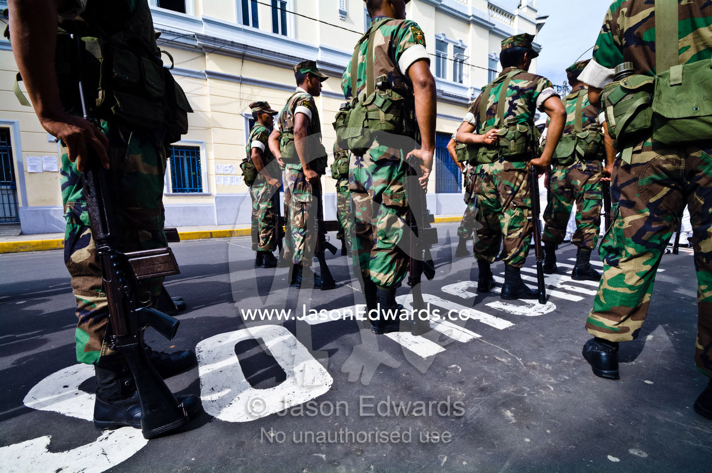 Army soldiers standing in formation with their rifles at a military parade honoring fallen comrades. Plaza de Armas, Iquitos, Amazon Basin, Loreto Region, Maynas Province, Peru.