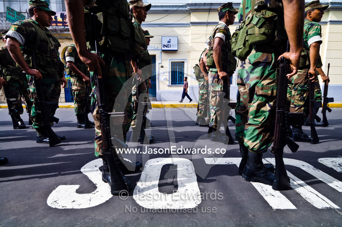 Army soldiers standing in formation with their rifles at a military parade honoring fallen comrades. Plaza de Armas, Iquitos, Amazon Basin, Loreto Region, Maynas Province, Peru.