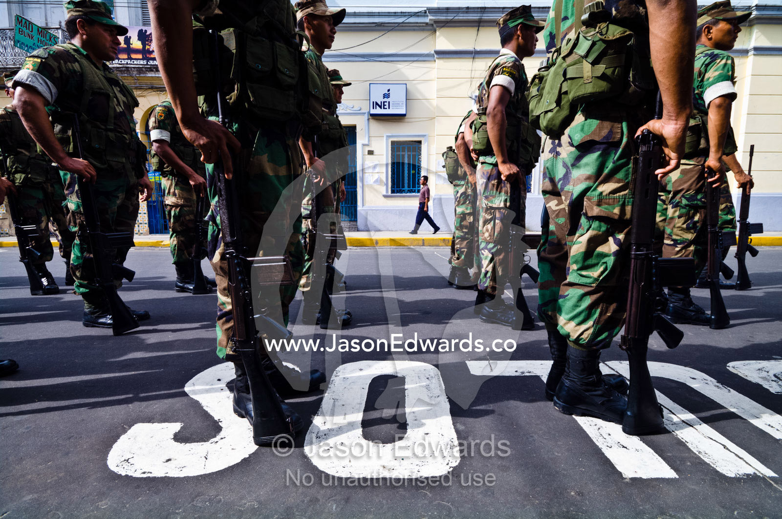 Army soldiers standing in formation with their rifles at a military parade honoring fallen comrades. Plaza de Armas, Iquitos, Amazon Basin, Loreto Region, Maynas Province, Peru.