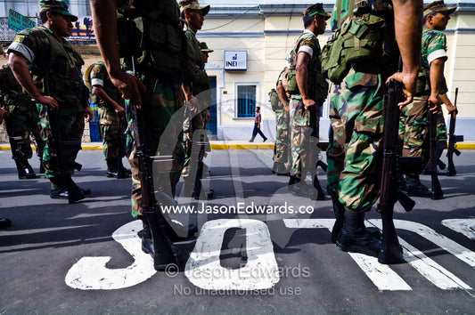Army soldiers standing in formation with their rifles at a military parade honoring fallen comrades. Plaza de Armas, Iquitos, Amazon Basin, Loreto Region, Maynas Province, Peru.