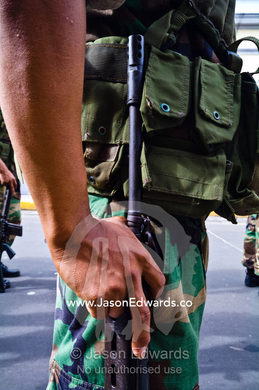Army soldiers standing in formation with their rifles at a military parade honoring fallen comrades. Plaza de Armas, Iquitos, Amazon Basin, Loreto Region, Maynas Province, Peru.
