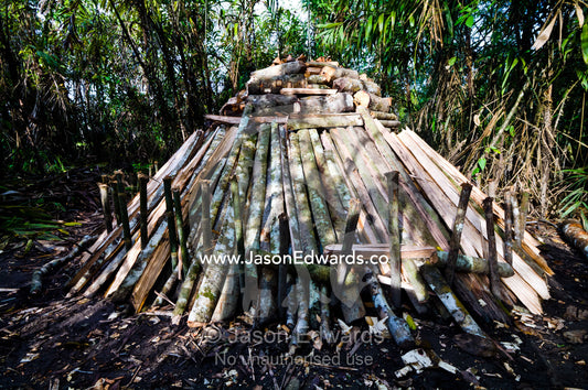 A timber log furnace used to create charcoal for villages in the Amazon rainforest. Pacaya Samiria National Reserve, Reserva Nacional Pacaya Samiria, Amazon River, Maranon River, Ucayali River, Rio Amazonas, Rio Maranon, Rio Ucayali, Loreto Region, Maynas Province, Amazon Basin, Peru.