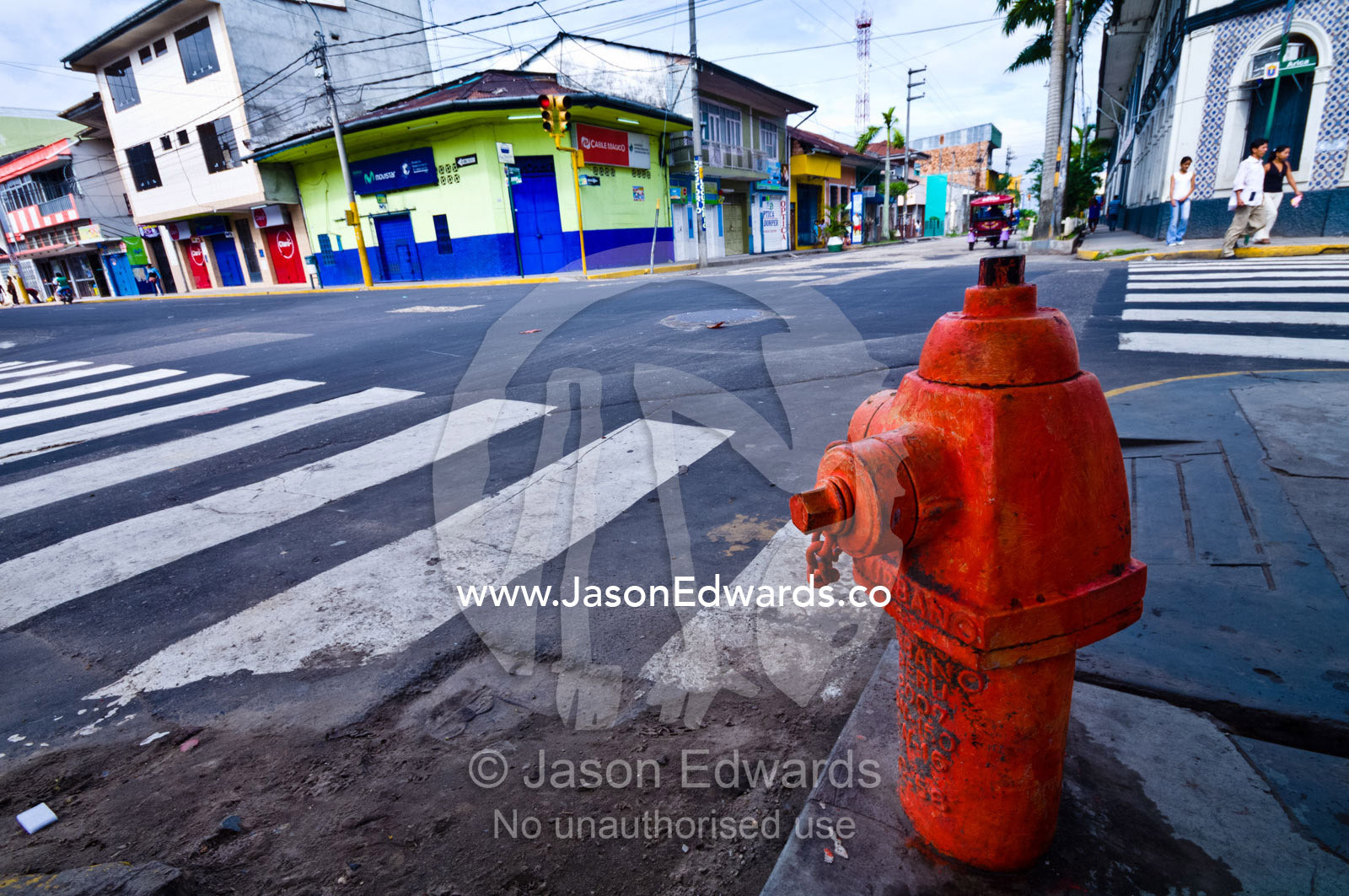 A red fire hydrant at a street intersection of an Amazonian river town. Iquitos, Amazon Basin, Loreto Region, Maynas Province, Peru.