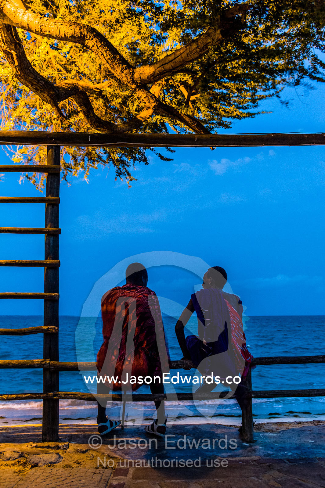 Young Masai warriors lured to the city wait to entertain guests at a seaside hotel. Dar es Salaam, Kawe, Tanzania, Africa.