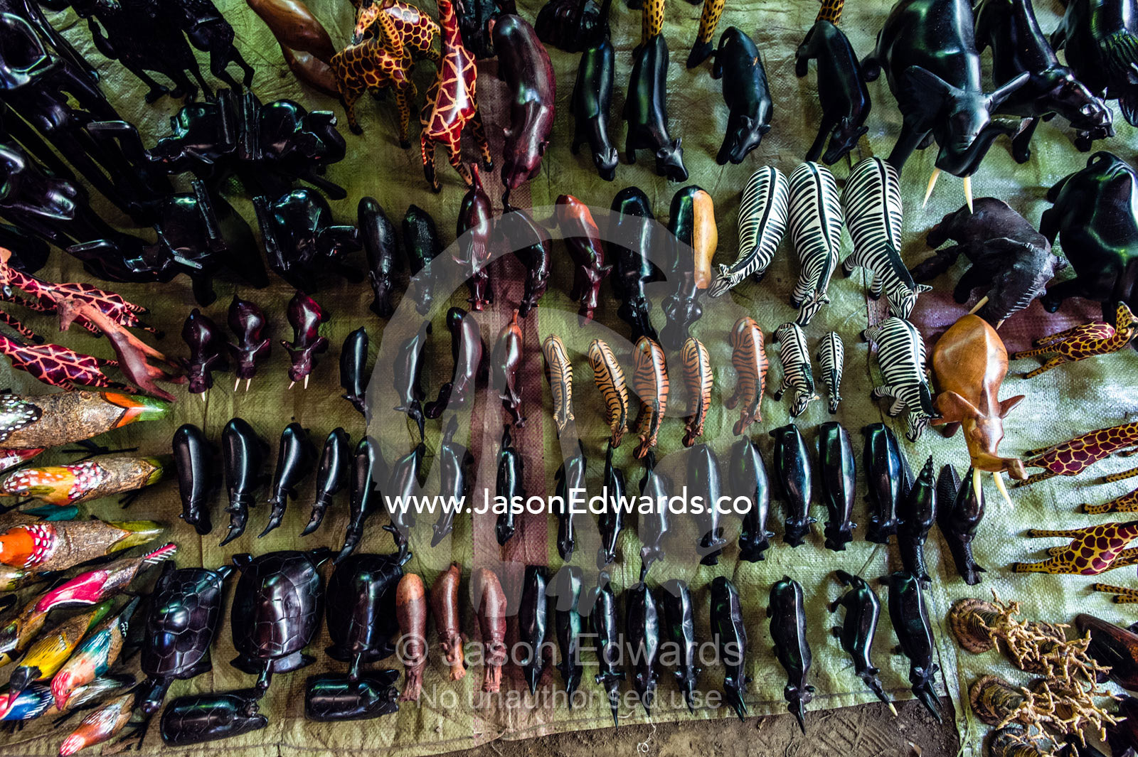 Carved and stained wooden toy animals for sale in an African village. Mto Wa Mbu, Lake Manyara National Park, Monduli District, Arusha Region, Tanzania.