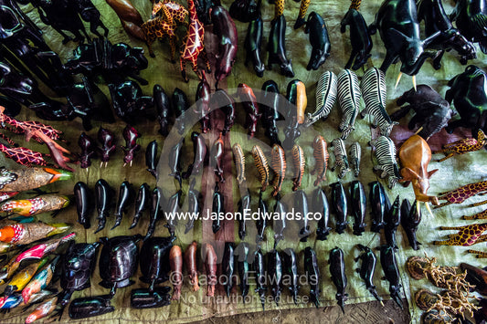 Carved and stained wooden toy animals for sale in an African village. Mto Wa Mbu, Lake Manyara National Park, Monduli District, Arusha Region, Tanzania.