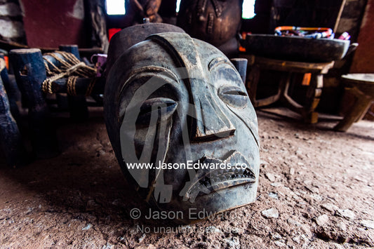 A fearsome African mask carved from wood for sale in a village. Mto Wa Mbu, Lake Manyara National Park, Monduli District, Arusha Region, Tanzania.